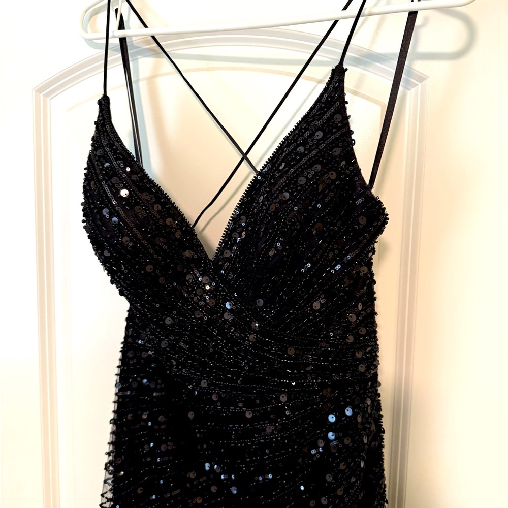 Beautiful beaded black prom dress with feathers.